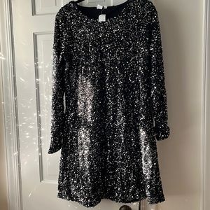 Knee-length black knit A-line dress, dk gray sequins, long sleeves.